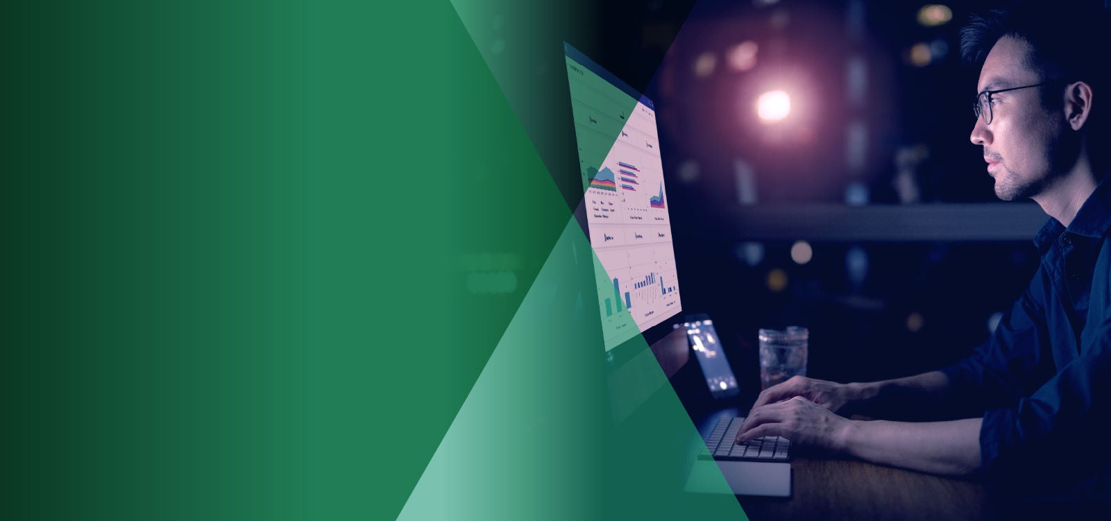 Man working on financial charts on computer