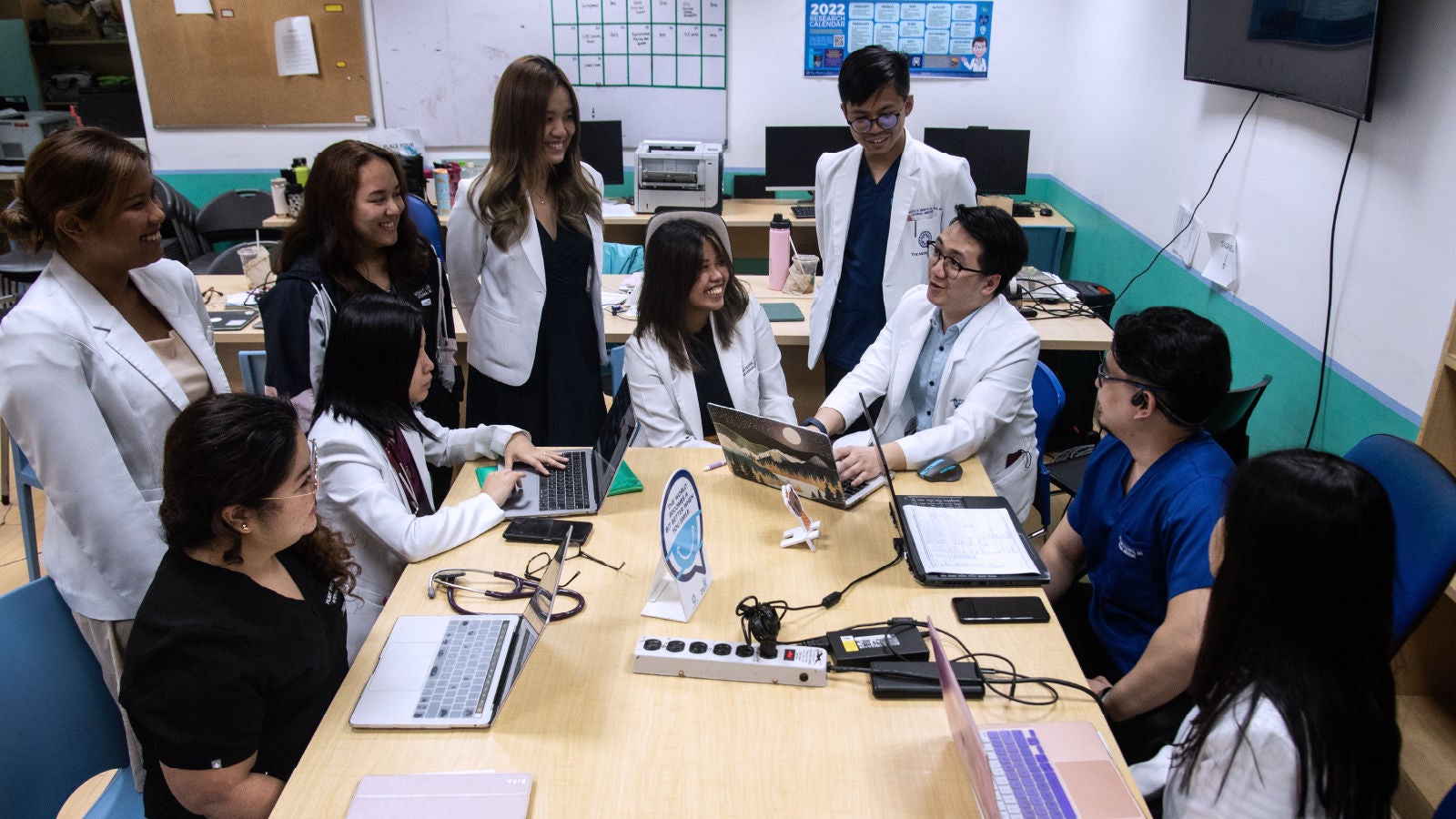 A group of doctors sitting at a table chatting
