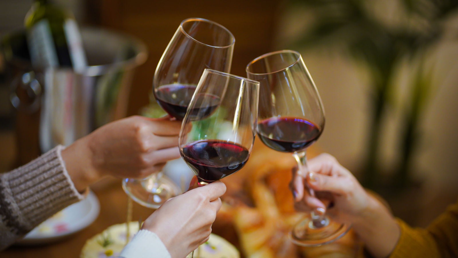 people havng a cheers with red wine