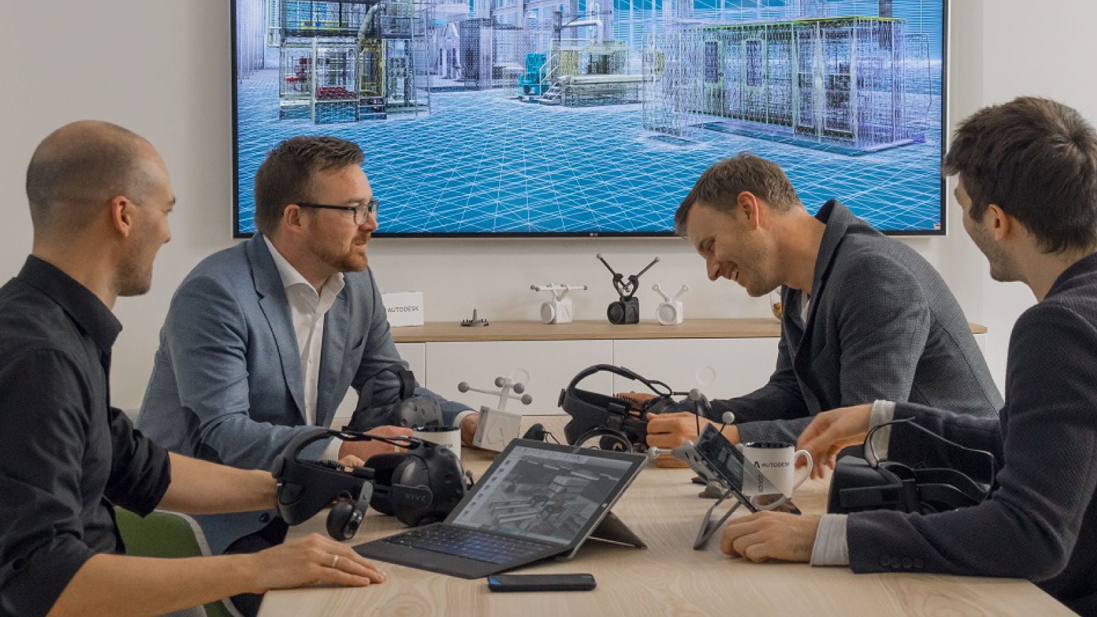 Men testing VR headsets in a Autodesk office setting.
