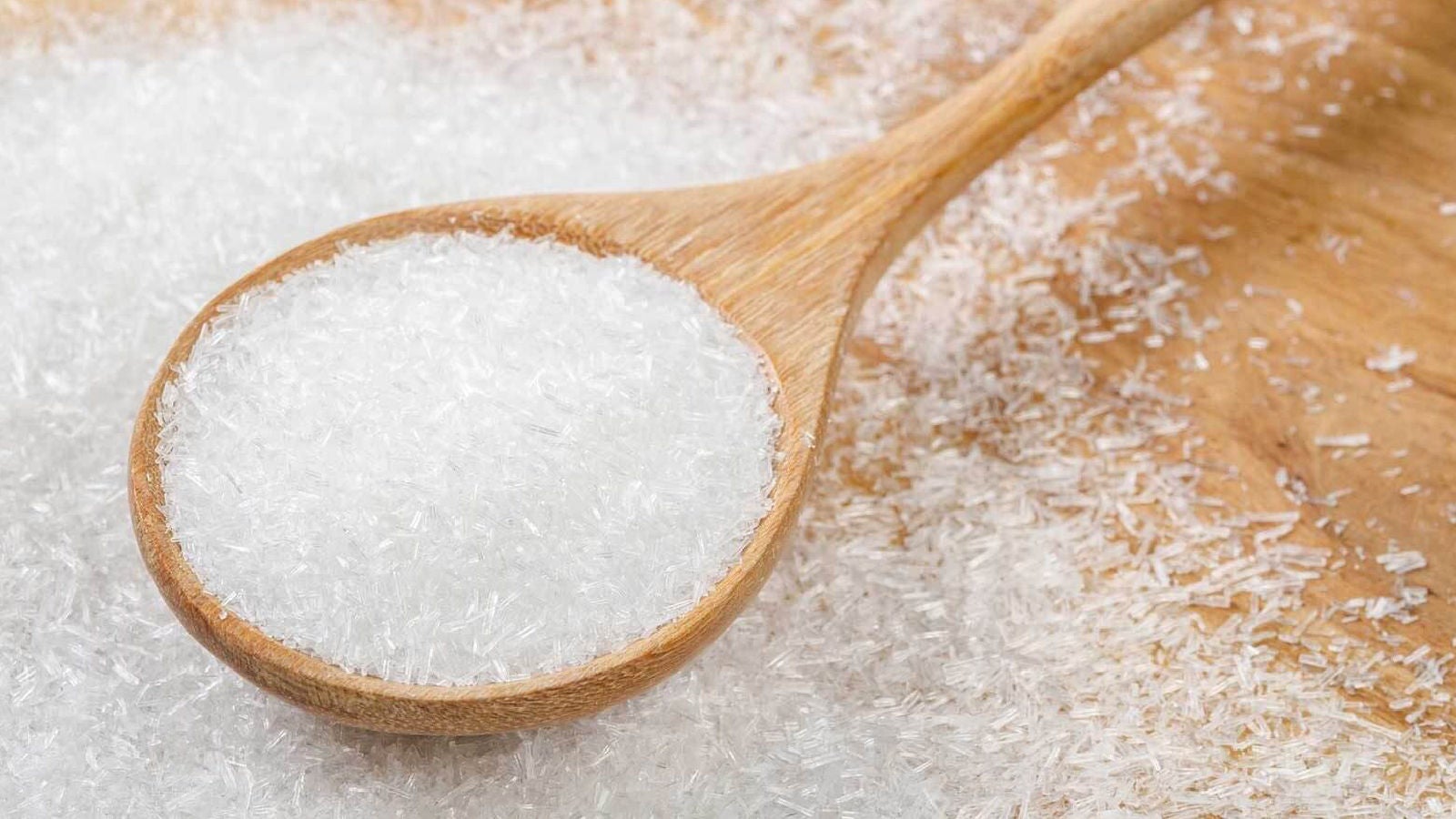 Wooden spoon scooping white rice