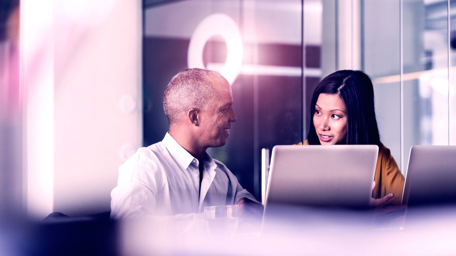 two coworkers collaborating in an office