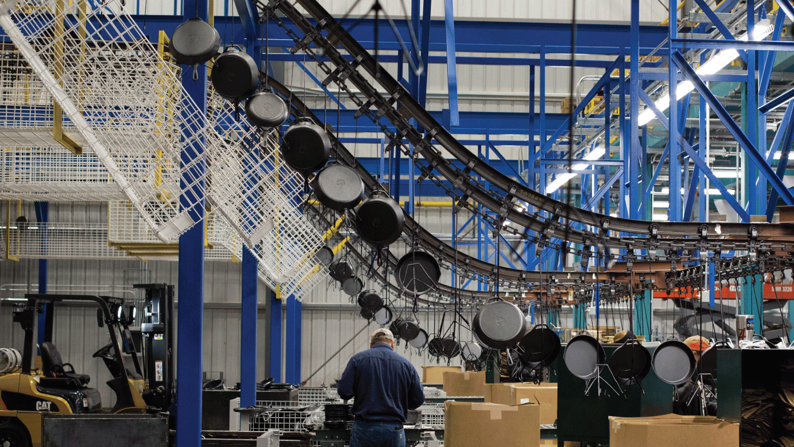 Cast iron cookware moving through a conveyor system
