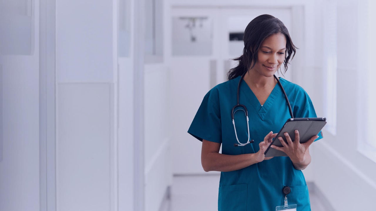 Medical professional holding a tablet