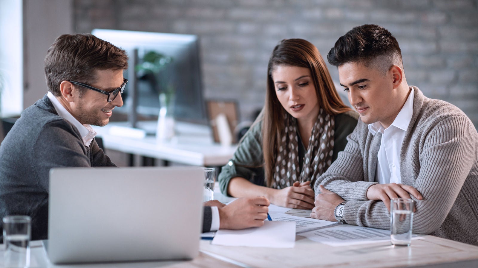 three people in a meeting