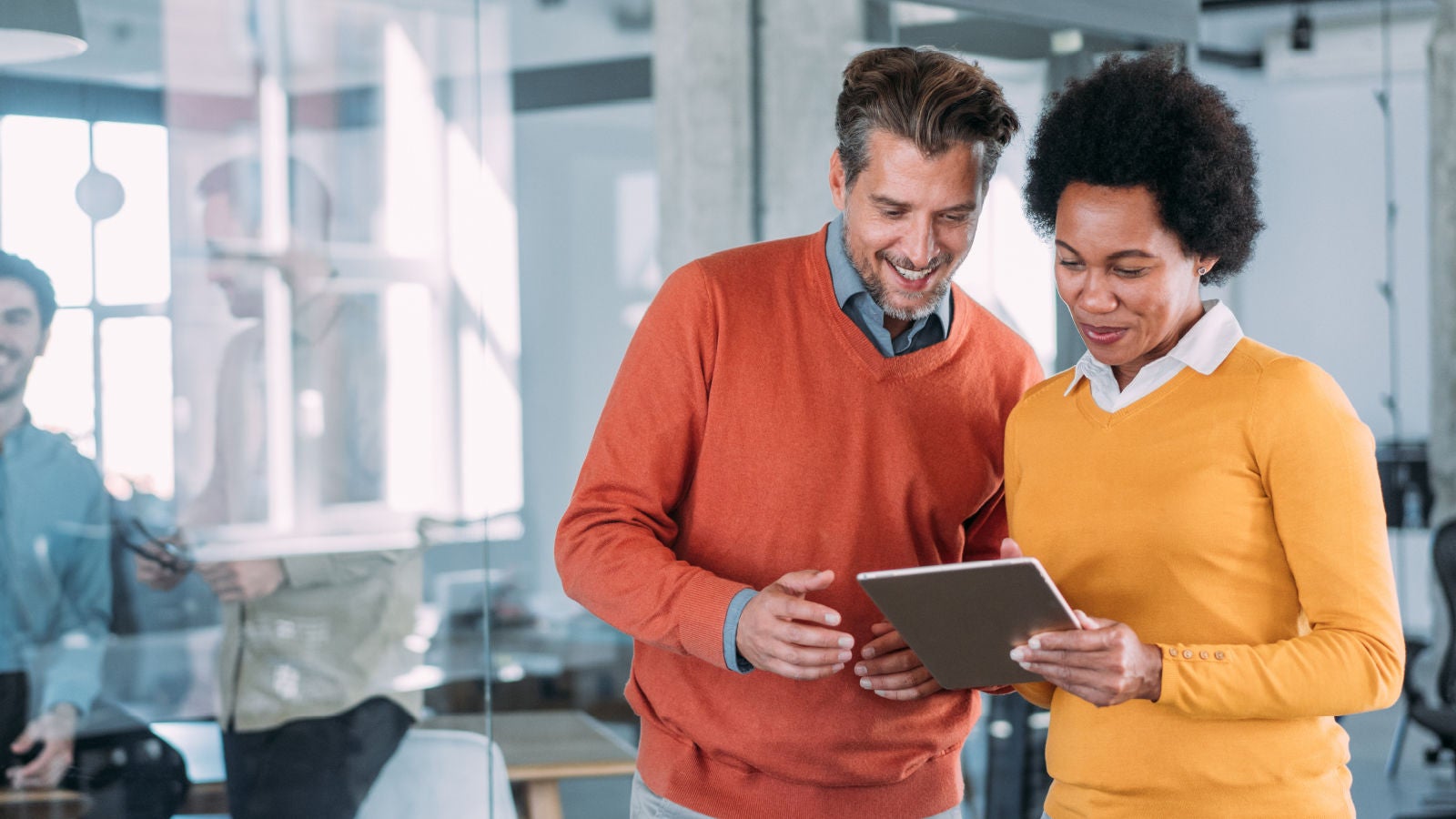Man and woman looking at a tablet together