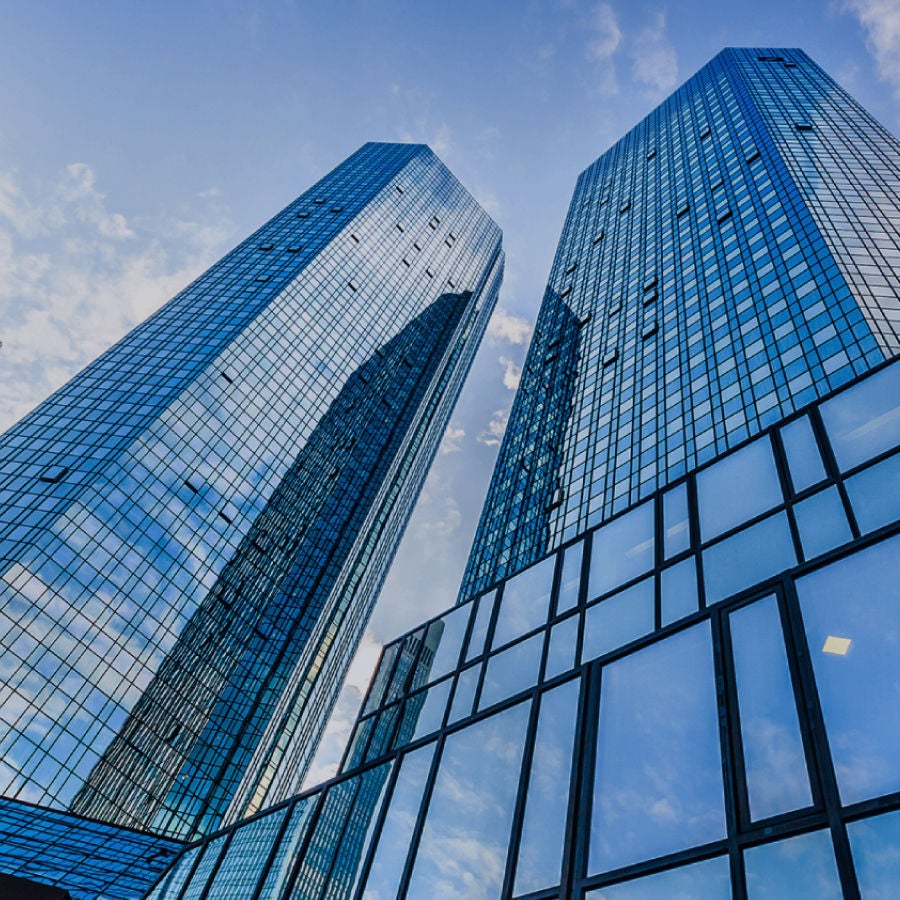 Two tall buildings featuring numerous windows and sleek glass walls, showcasing modern architectural design.
