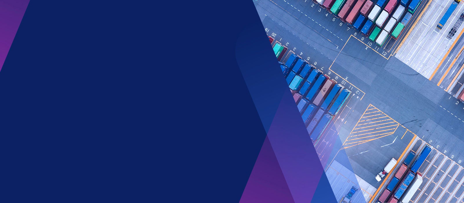 Aerial view of shipping containers stacked in shipping yard