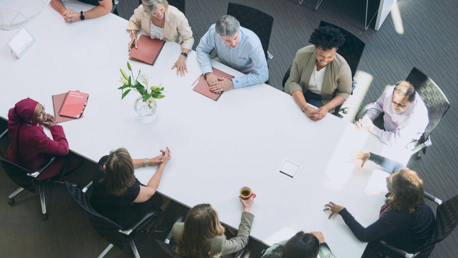 Aerial view of coworkers sitting around a conference table