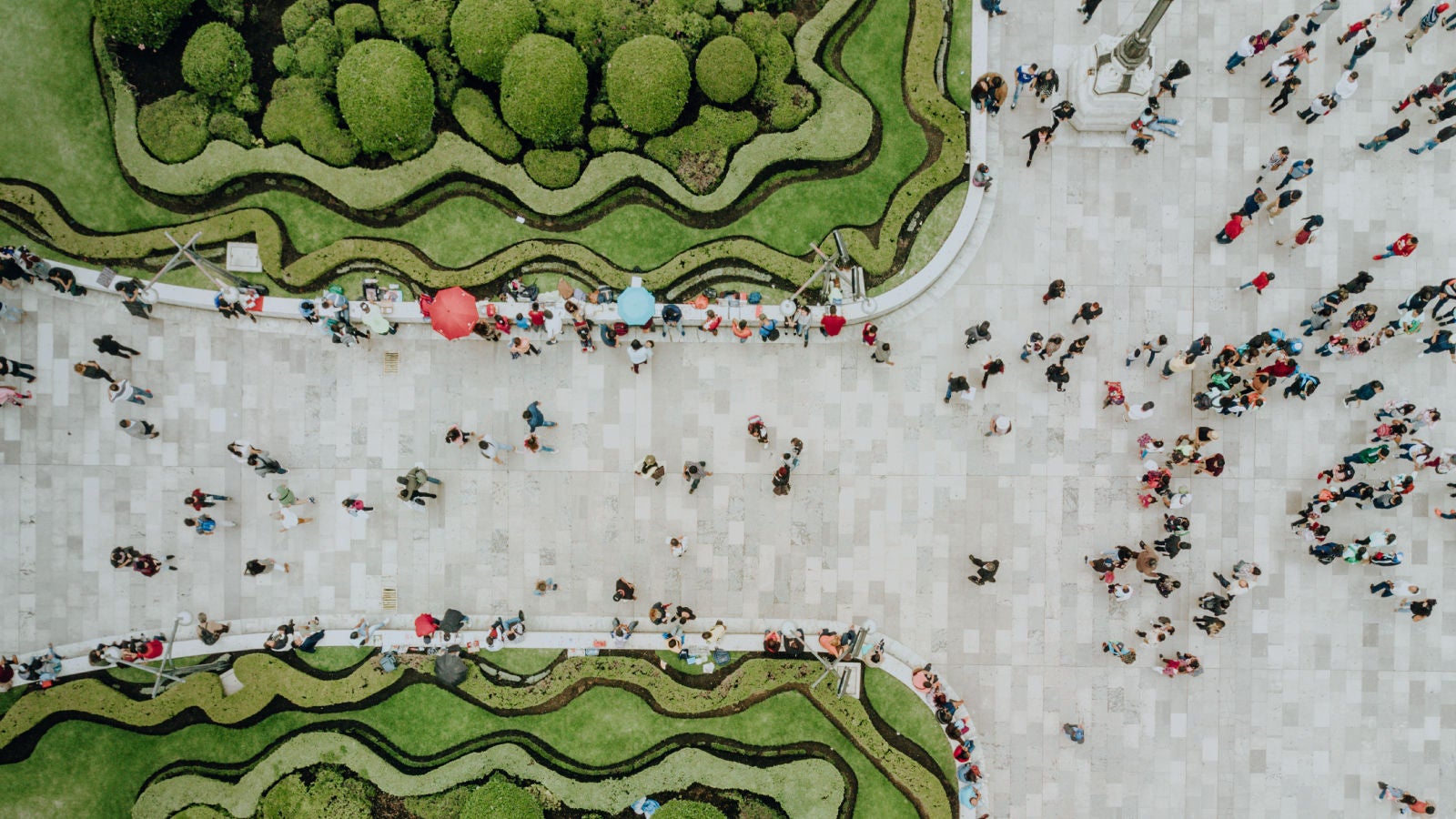 Overhead image of people walking in a city square