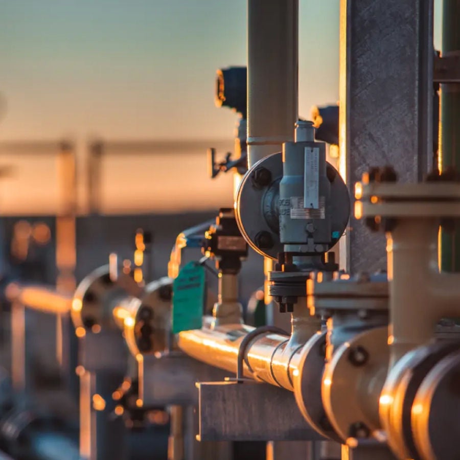 Industrial pipes and valves arranged in a complex network within a manufacturing facility.