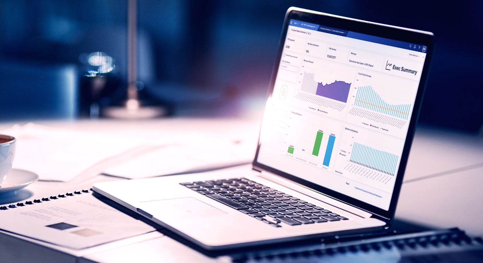Laptop computer on desk displaying graphical information