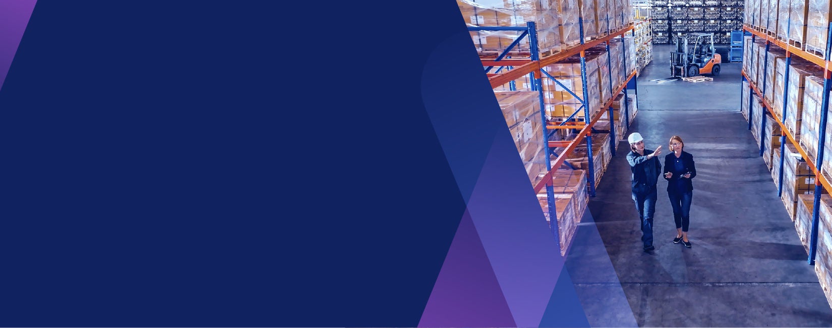 Two employees walking through a warehouse