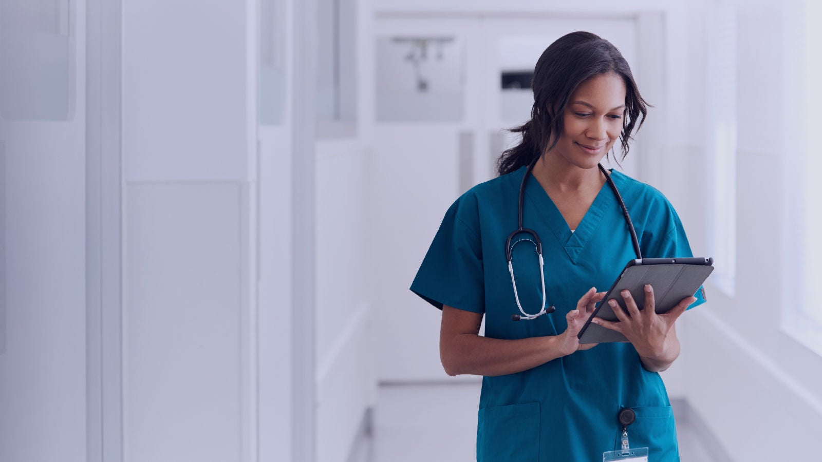 A nurse looking on an iPad