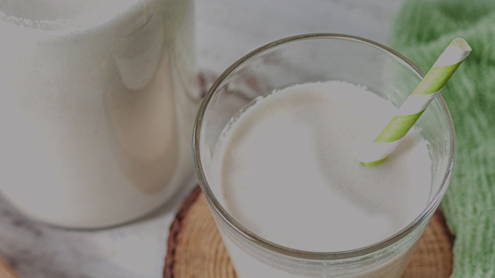 Glass of milk with paper straw