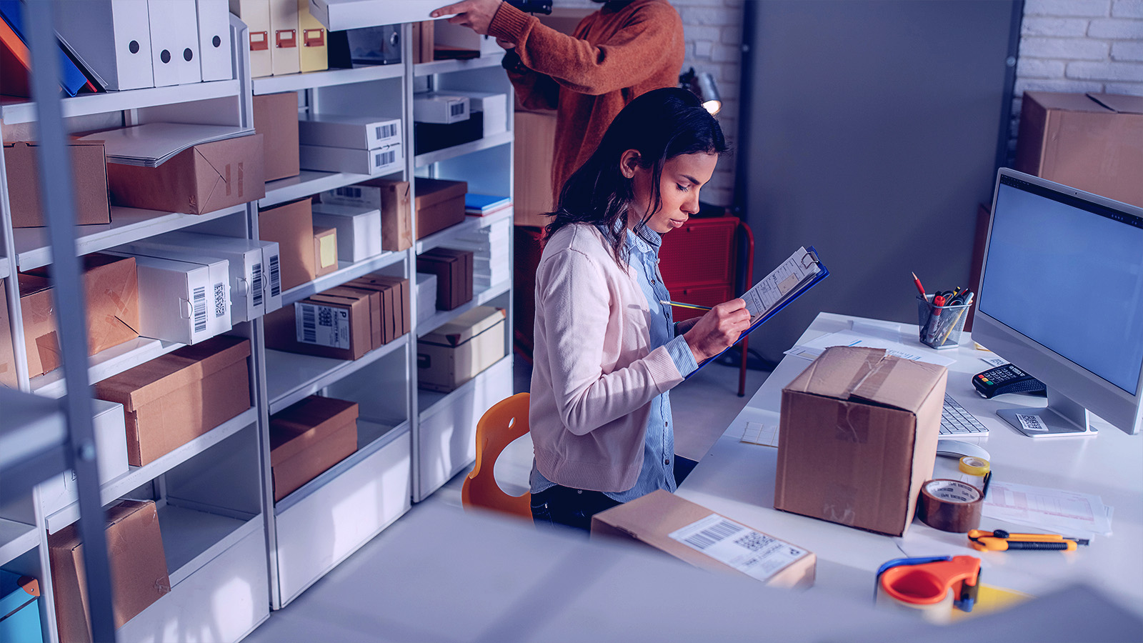 Coworkers in an office working with packaging materials dressed business casual