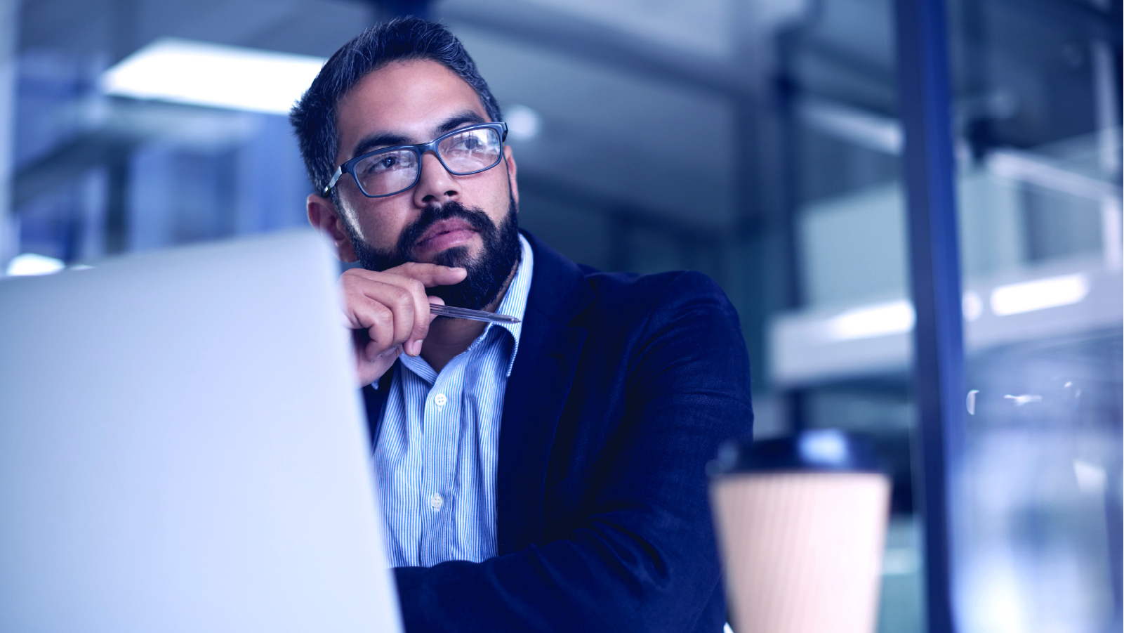 Business person dressed business casual pondering