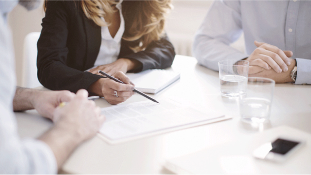 Coworkers sitting at a table reviewing a document