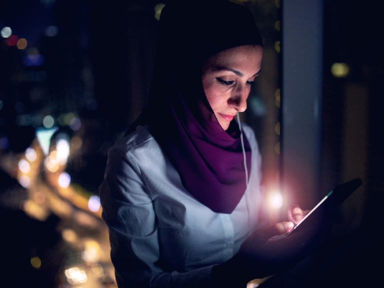 Woman in hijab using mobile device